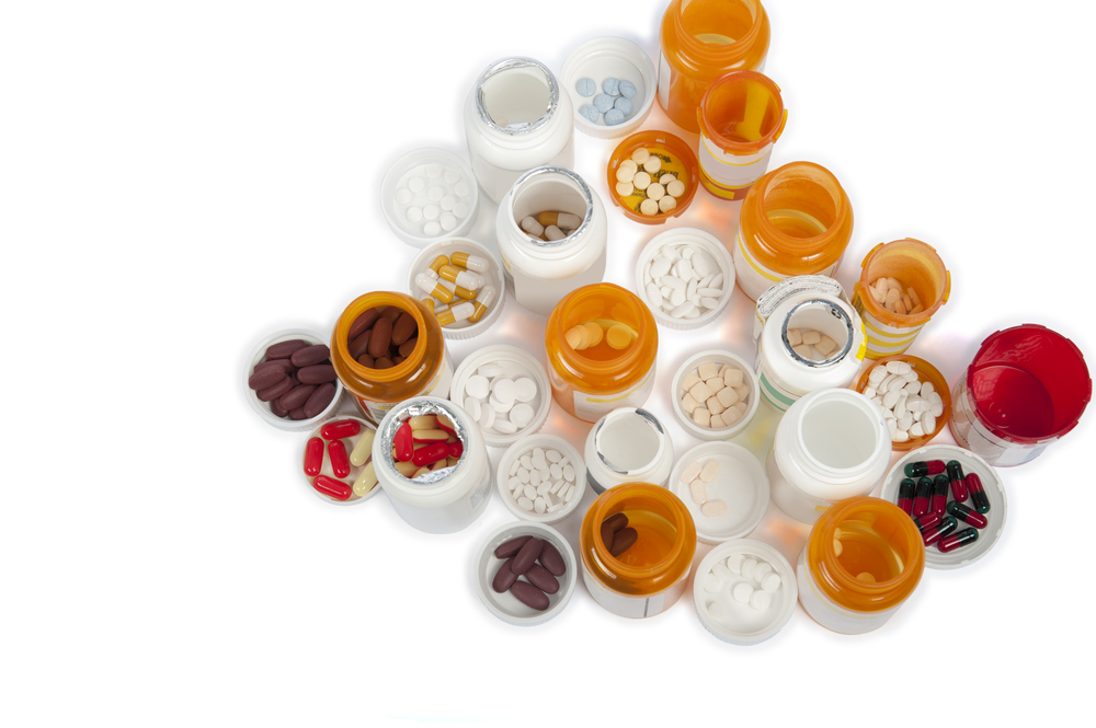 A,bird's,eye,view,of,multiple,medicine,bottles,and,pills