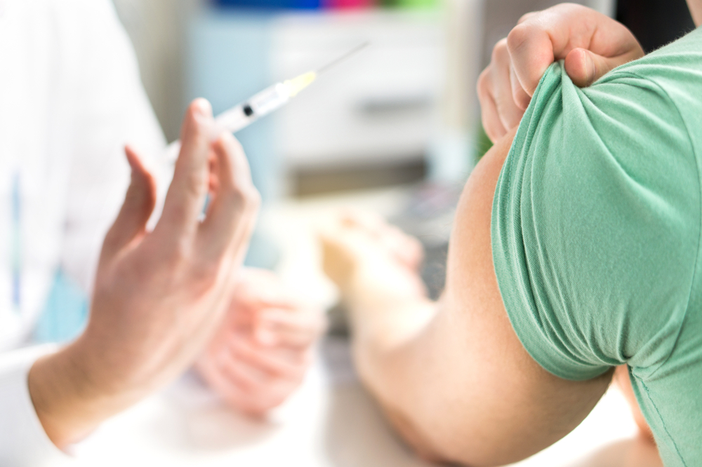 Doctor,giving,patient,vaccine,,flu,or,influenza,shot,or,taking